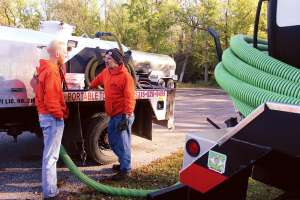 Setting Up Restrooms Along Rustic North Woods Paths